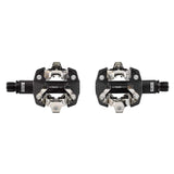 Look X-Track Race MTB pedals with SPD compatibility, adjustable tension, mud-shedding design, shown mounted on a mountain bike.