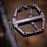 Look Trail Roc flat pedals with concave platform and traction pins in purple, designed for mountain biking components.