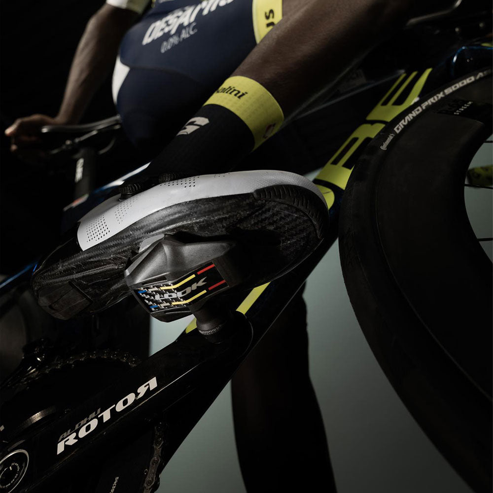 Look Keo Blade Ti ceramic road bike pedals with 12° float and 56mm Q-Factor, showcasing sleek titanium design and pedal cleats.
