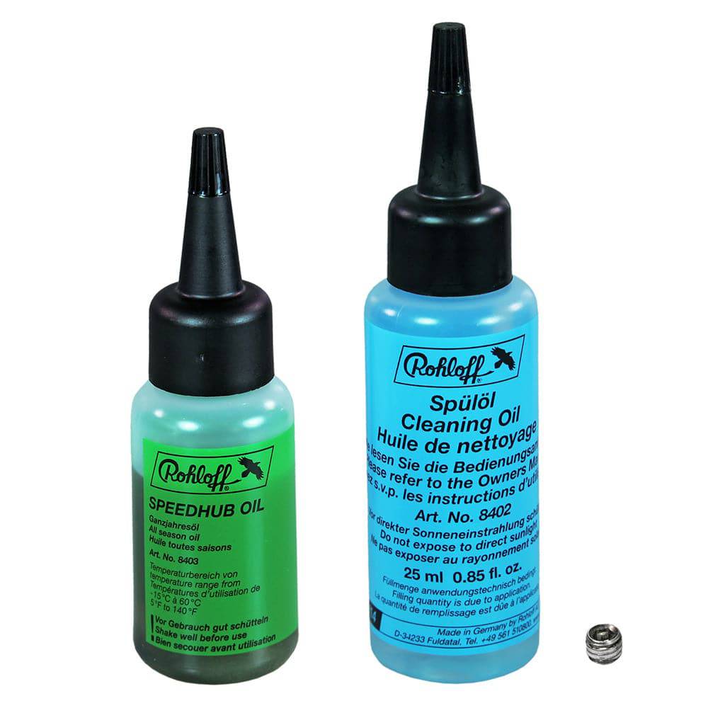 Rohloff Transmission Lube bottle for smooth gear shifts and protection, held in a workshop setting.