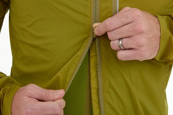 Madison Roam men's lightweight windproof packable jacket displayed on a hanger, showing its sleek design and compact portability.