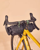 Miss Grape Tendril 4.10 waterproof handlebar bag with adjustable straps, designed for bike accessories, shown attached to a bicycle handlebar.