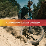 Finish Line BOOSTEDT Bio Wax chain lubricant in a 32oz eco-friendly plant-based bottle, displayed in a workshop setting.