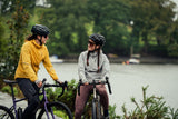 Madison Roam Women's lightweight windproof packable jacket displayed, showing front view with hood and zipped pockets.