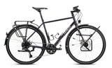 Genesis Tour de Fer 30 2026 touring bike with Shimano 2x10-speed drivetrain and dynamo lighting, ready for long-distance cycling.