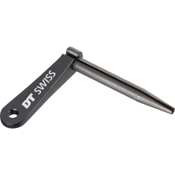 Black DT Swiss Aero Bladed Spoke Holder for Aero Comp and New Aero spokes, shown on a workshop workbench.