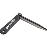 Black DT Swiss Aero Bladed Spoke Holder for Aero Comp and New Aero spokes, shown on a workshop workbench.