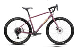 Genesis Vagabond 10 gravel bike with 10-speed MicroShift drivetrain and TRP Spyre mechanical brakes, featuring a rugged frame and knobby tires.